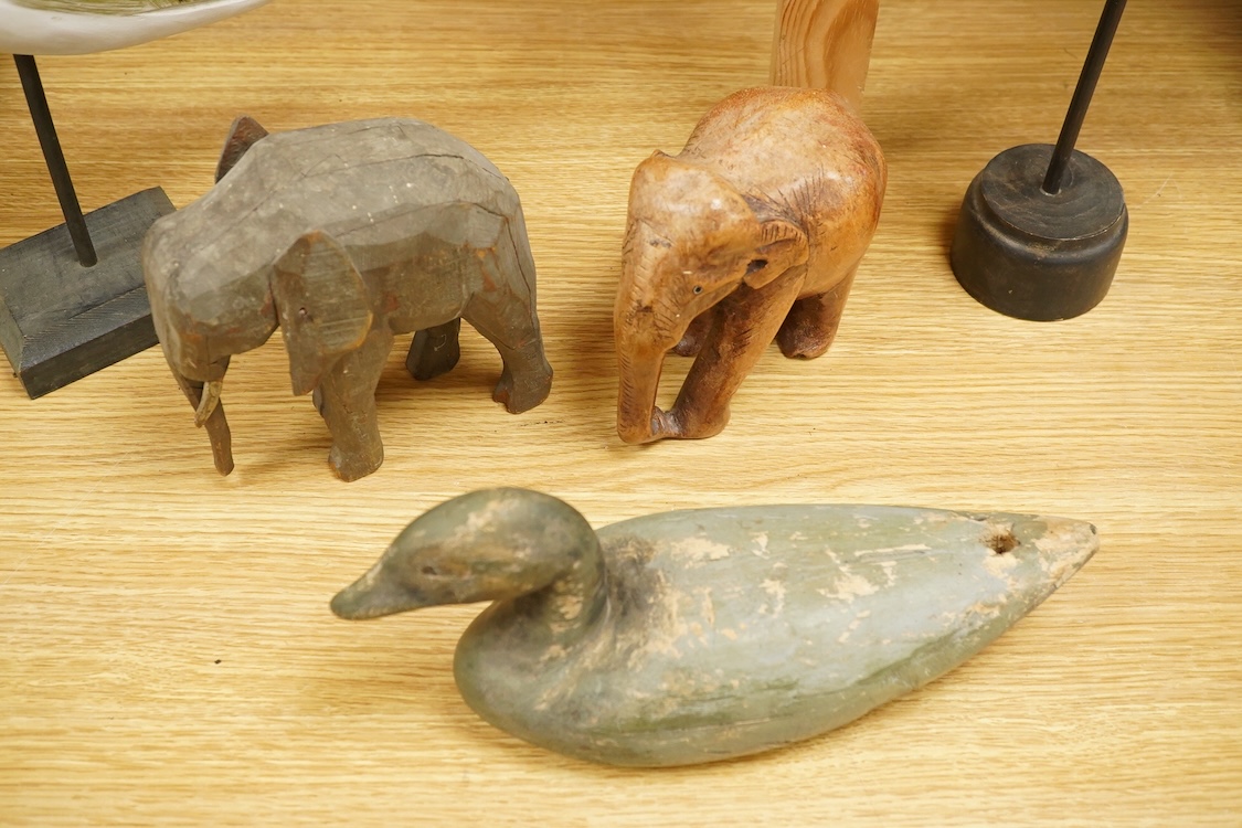 A carved and painted decoy duck, two carved elephants and two other painted birds, tallest 41cm